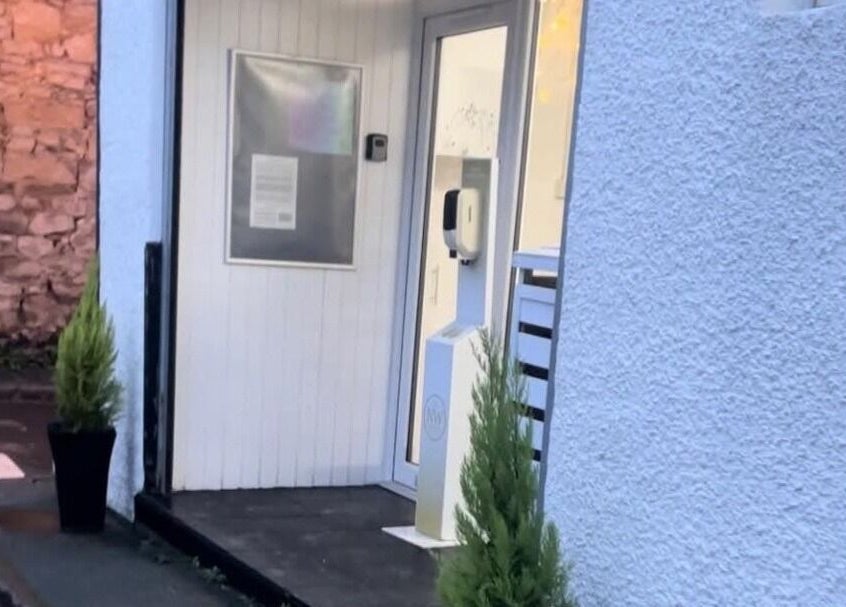 Entrance of Solace Head Spa in Llandudno, Wales, GB with elegant plant decor.
