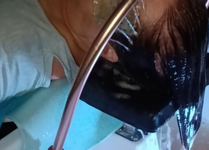 Refreshing head rinse at Solace Head Spa in Llandudno, Wales, GB, showcasing relaxing spa experience.