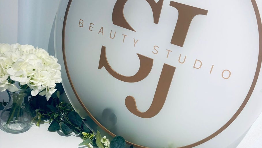 SJbeautystudio logo with white flowers in Stevenage, England, GB showcasing a tranquil ambiance.