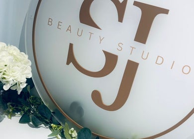 SJbeautystudio logo with white flowers in Stevenage, England, GB showcasing a tranquil ambiance.