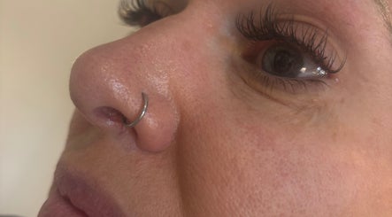 Close-up of nose with a hoop piercing at SJbeautystudio, Stevenage, England, GB.