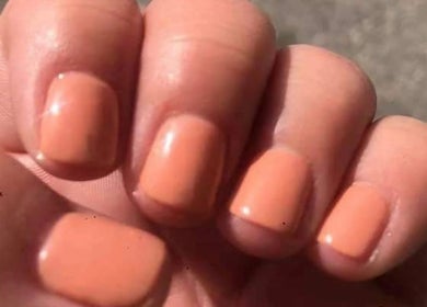 Close-up of peach manicured nails by Krystyn's Mobile Spa in Barrie, Ontario, CA showcasing expert nail care.