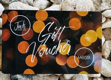 Gift voucher from JOELS Barber Shop | Eastville, Toowoomba, placed on rocks in East Toowoomba, Queensland, AU.