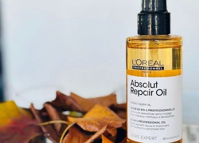 L'Oréal Absolut Repair Oil displayed at MOSTA Hair | Eastville, Toowoomba, Queensland, AU with autumn leaves.