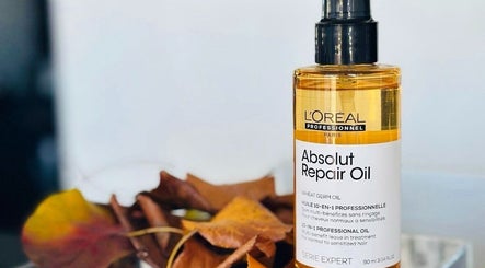 L'Oréal Absolut Repair Oil displayed at MOSTA Hair | Eastville, Toowoomba, Queensland, AU with autumn leaves.