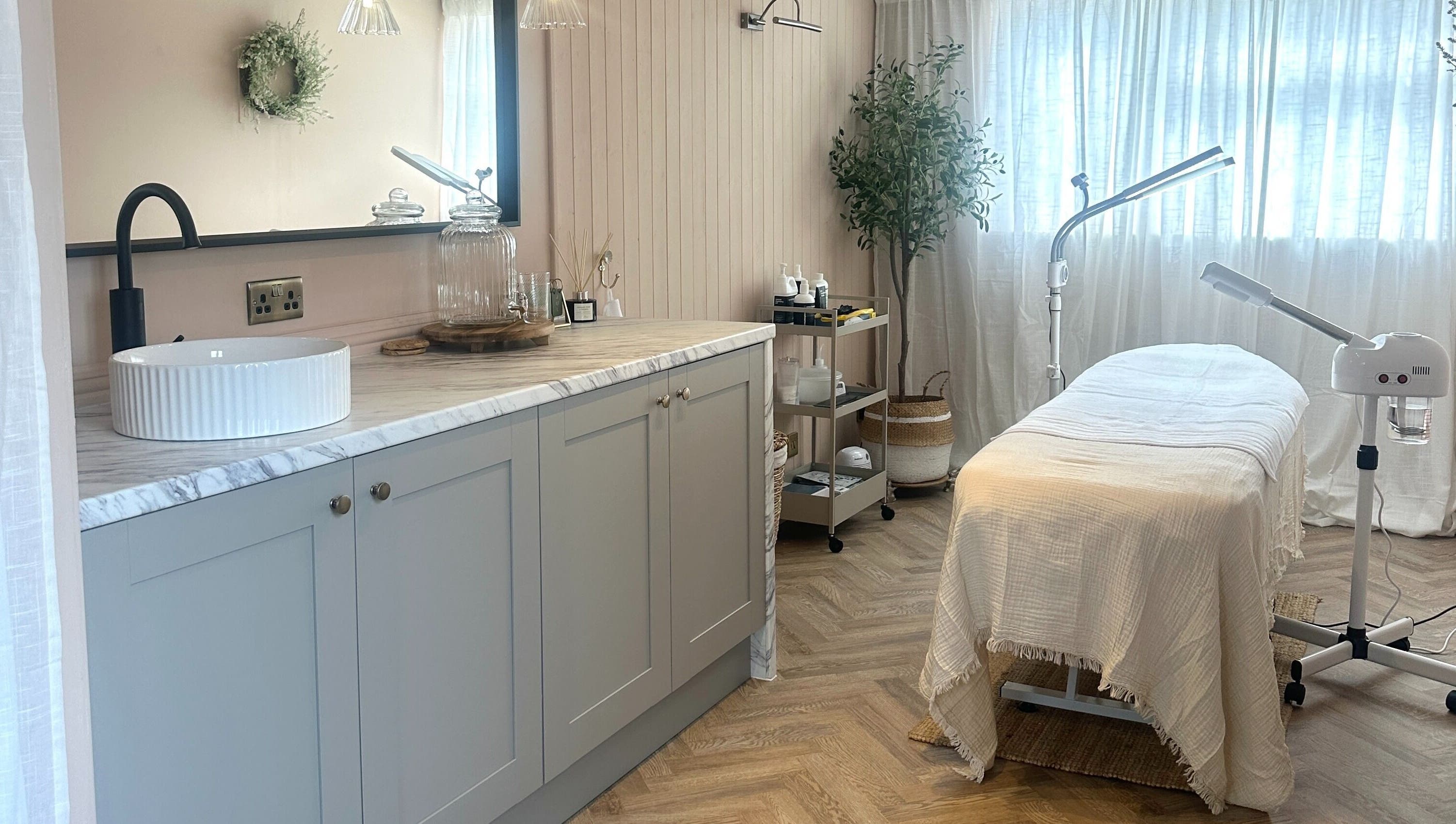 Elegant treatment room at Bare Willow Skin Clinic in Hinckley, England, GB, featuring spa bed and soothing decor.