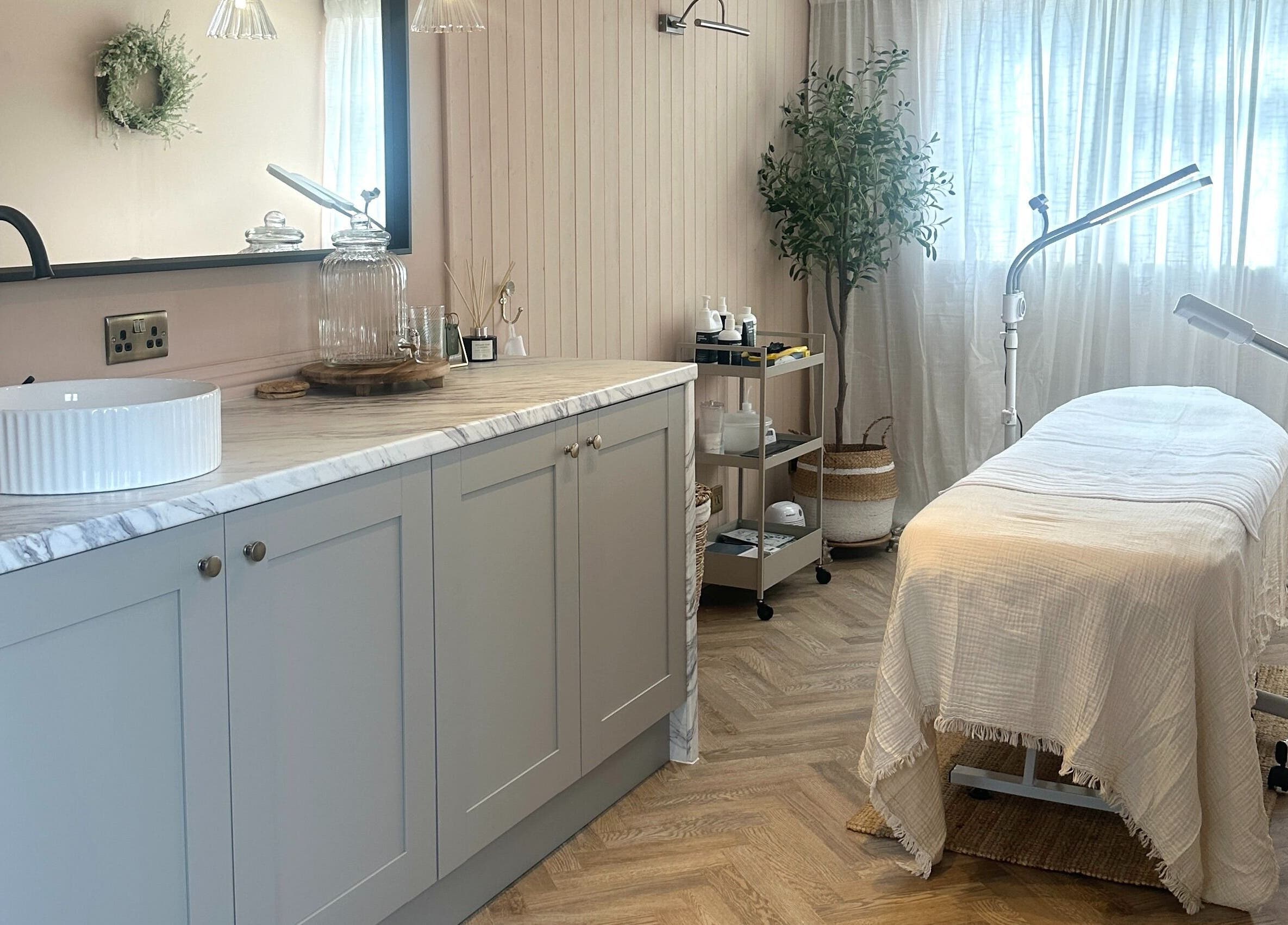 Elegant treatment room at Bare Willow Skin Clinic in Hinckley, England, GB, featuring spa bed and soothing decor.