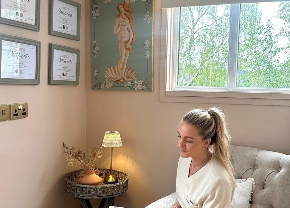 A tranquil room at Bare Willow Skin Clinic in Hinckley, England, GB, featuring certificates and a seated professional.