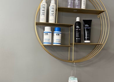 Stylish product shelf at Shelly’s hair salon in West Newton, Pennsylvania, US, showcasing premium hair care items.