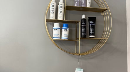 Stylish product shelf at Shelly’s hair salon in West Newton, Pennsylvania, US, showcasing premium hair care items.