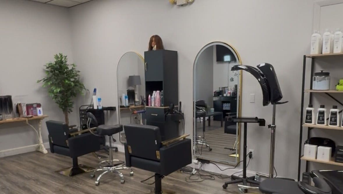 Stylish interior of Shelly’s Hair Salon in West Newton, Pennsylvania, US with modern styling stations and mirrors.