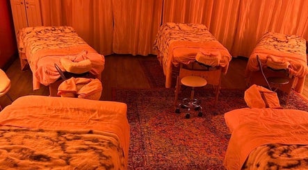 Relaxing massage room with four beds at TT-Key Massage Haven, El Paso, Texas, US, offering a soothing environment.