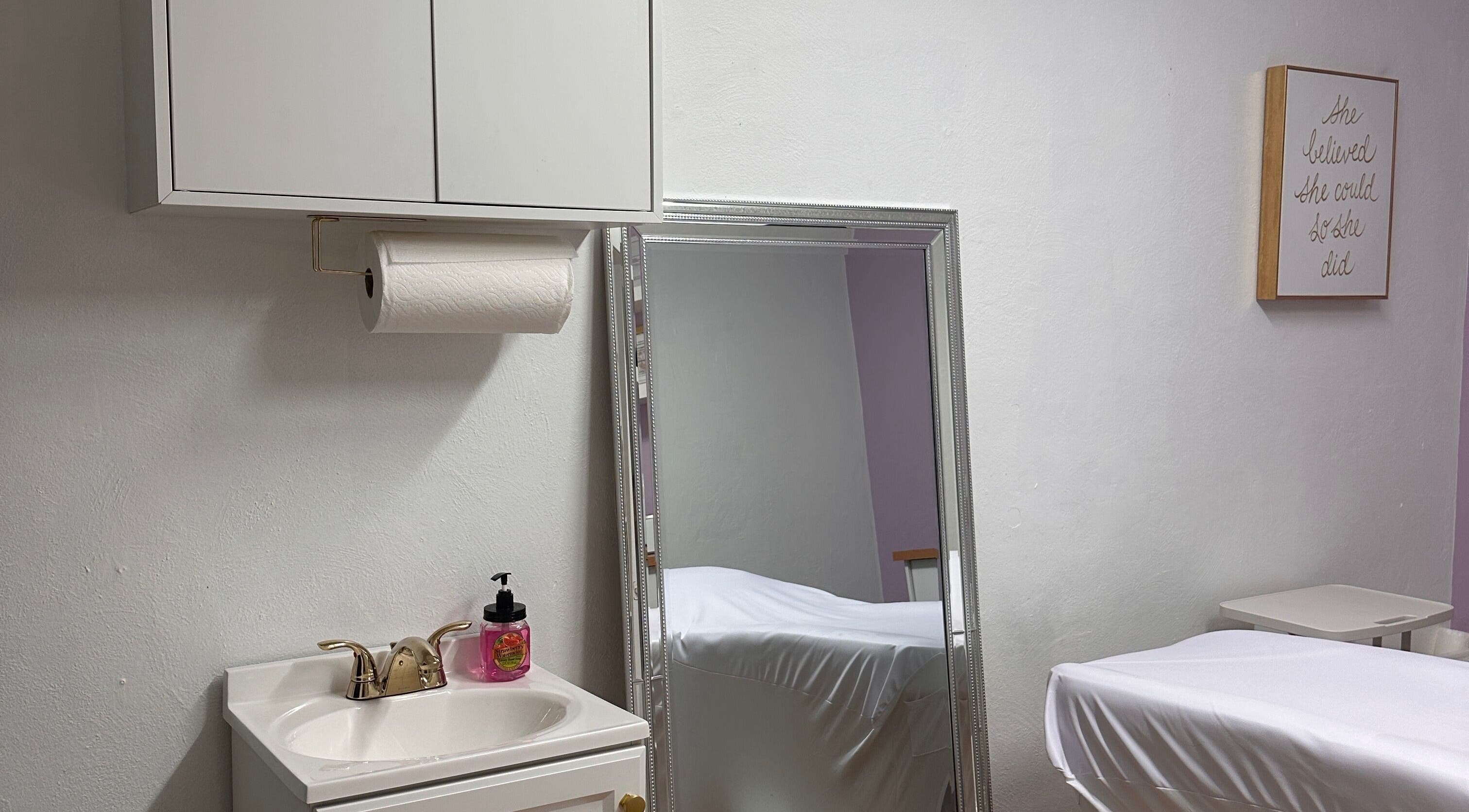 Relaxing treatment room at Waxing by Ana Spadeto in Pompano Beach, Florida, US with modern decor and mirror.