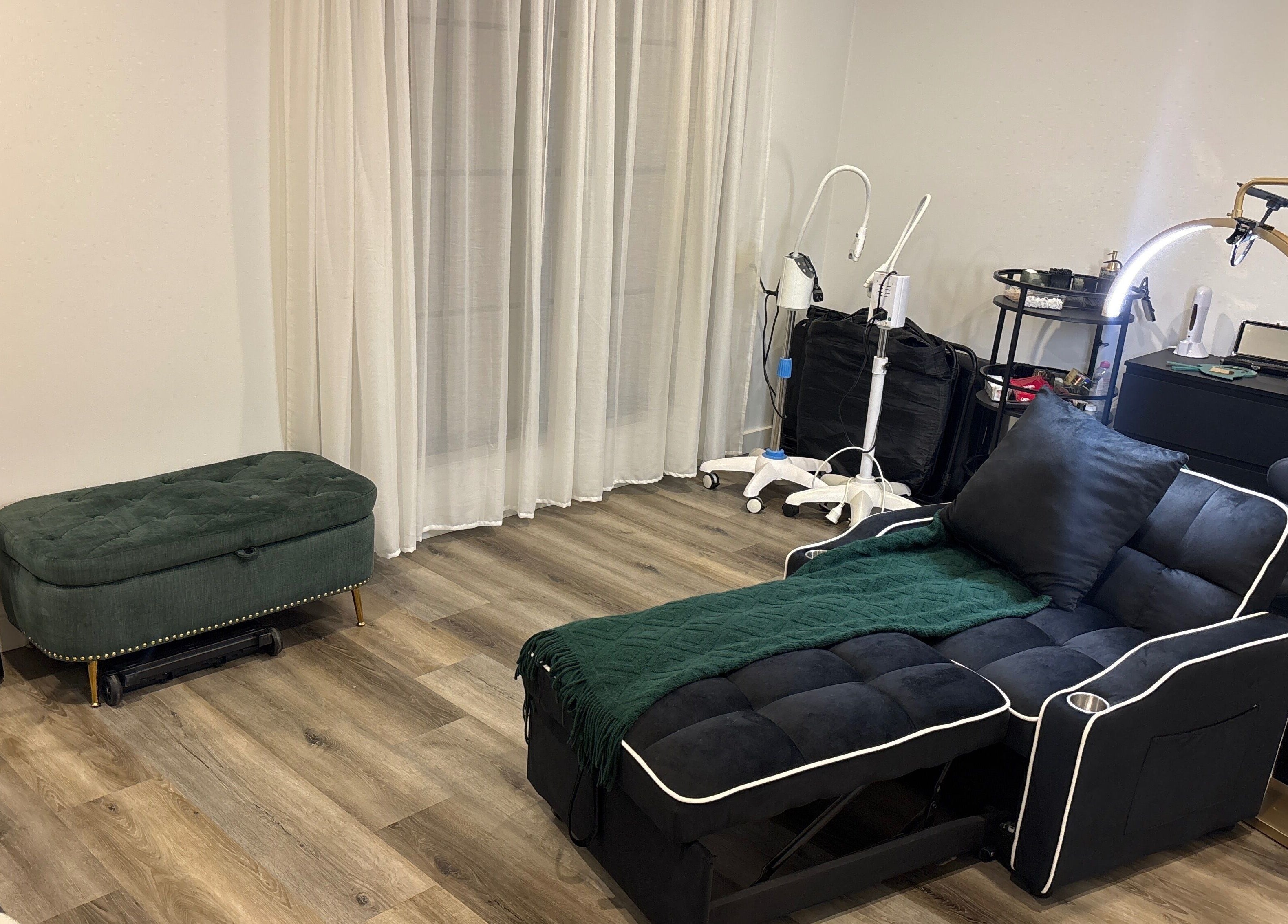 Luxurious beauty room at DĀNA X BEAUTY, Liverpool, New South Wales, AU with plush seating and modern equipment.