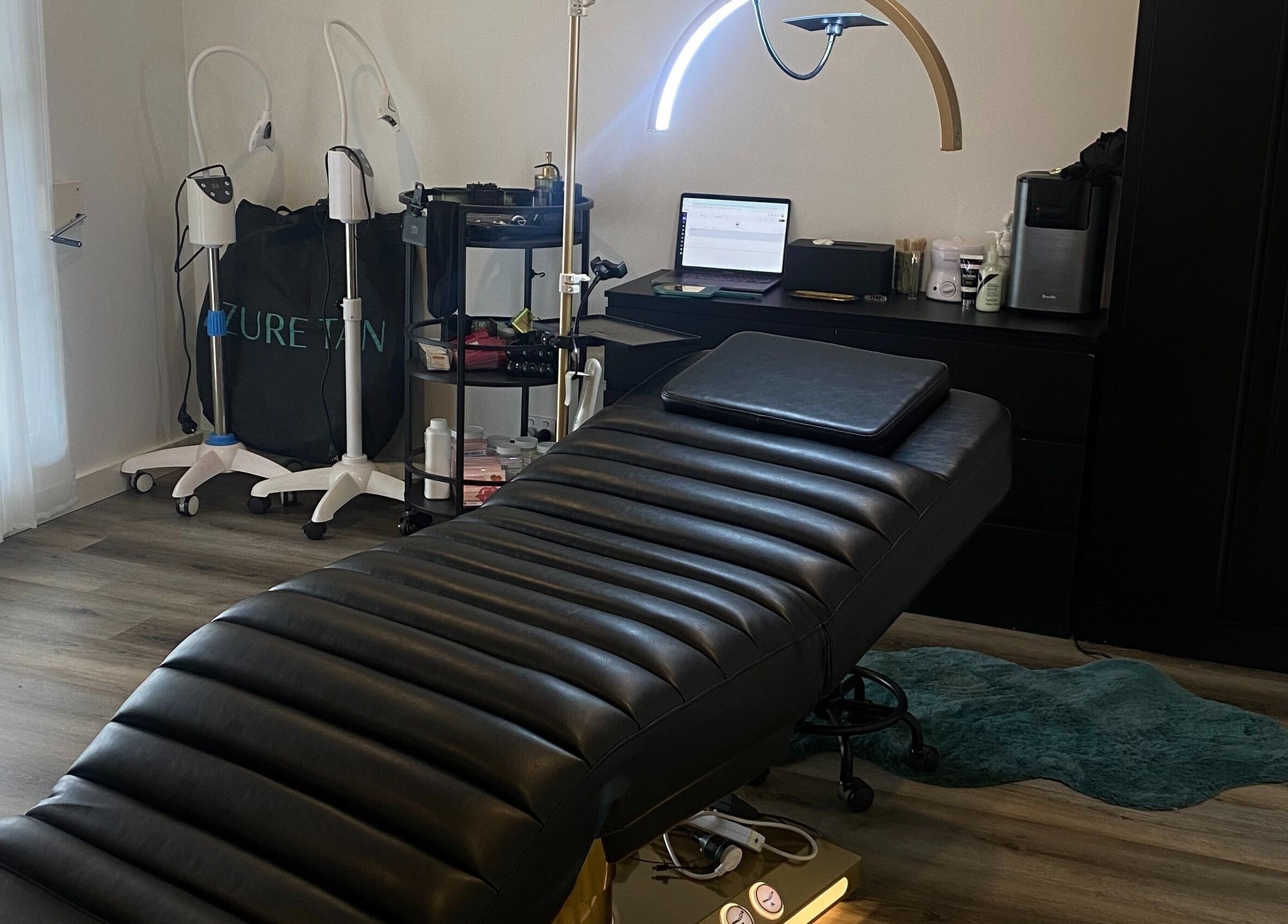 Tranquil spa room at DĀNA X BEAUTY, Liverpool, New South Wales, AU with modern equipment and plush black bed.