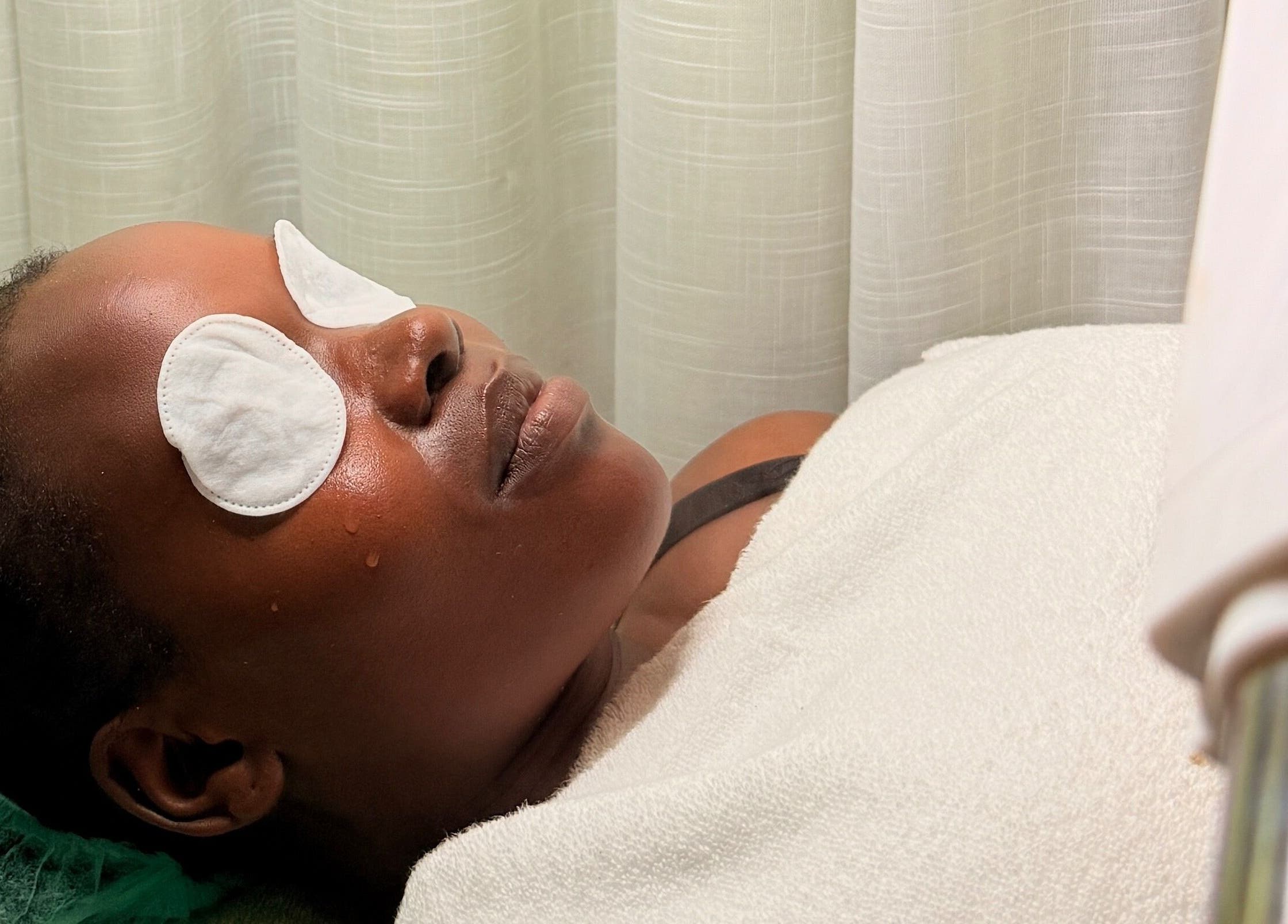 Relaxing facial treatment at PALM HOUSE ug in Mulawa, Central Region, UG, with soothing eye pads.