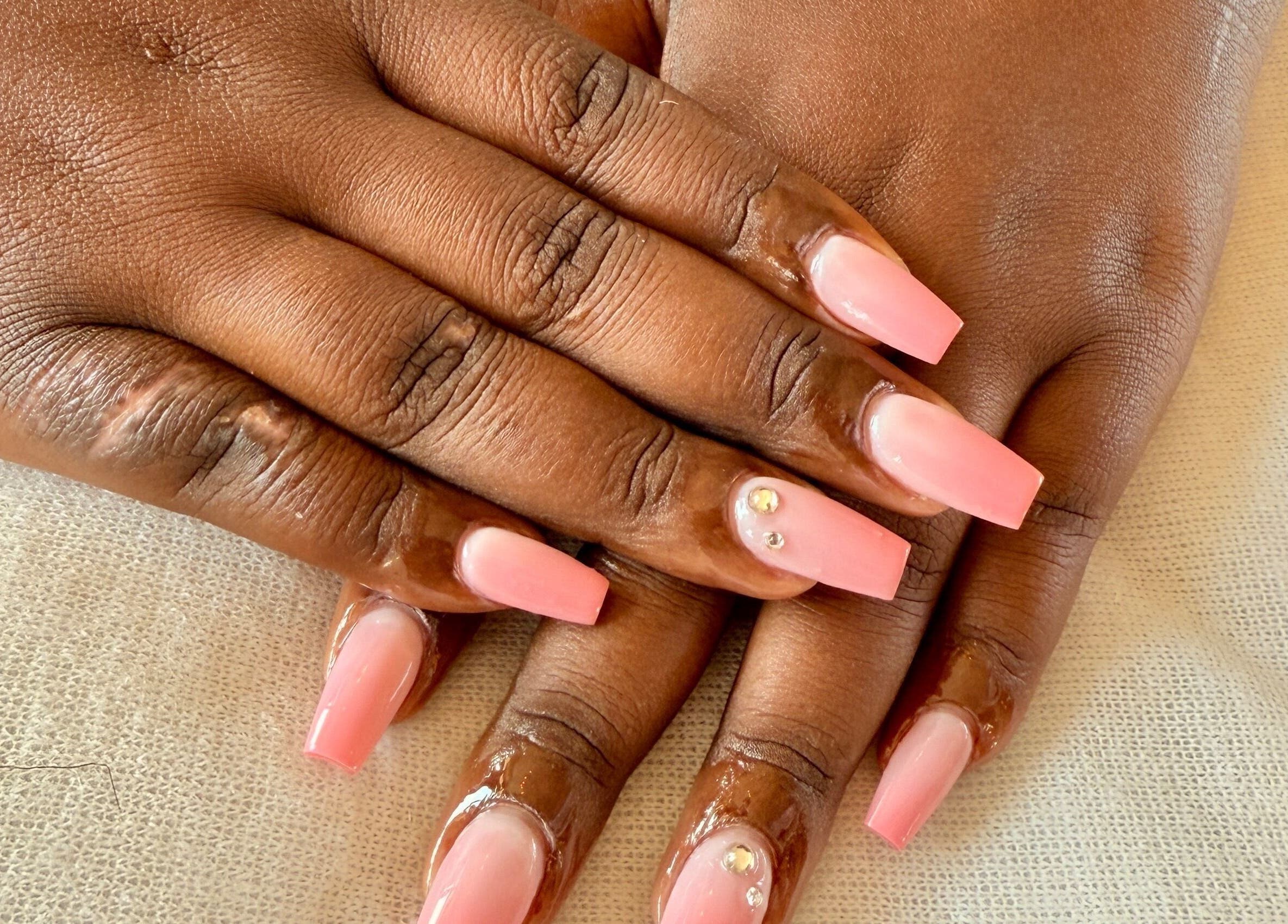 Pink manicured nails with gems at PALM HOUSE ug in Mulawa, Central Region, UG showcasing elegance.