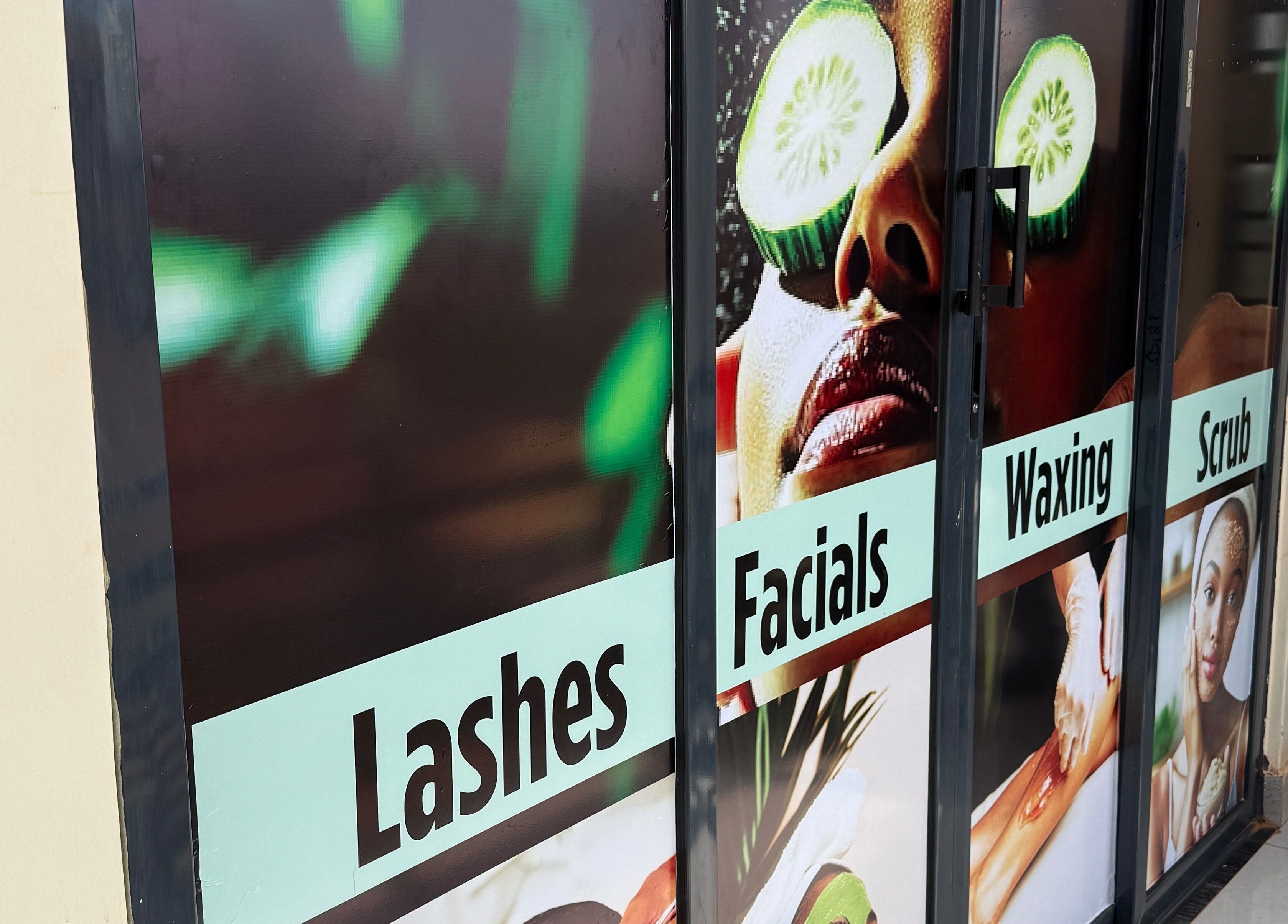 Services sign at PALM HOUSE ug in Mulawa, Central Region, UG showing lashes, facials, waxing, and scrub.