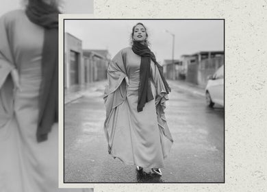 Elegantly dressed woman in Cape Town street, showcasing style at The Mas Method, Western Cape, ZA.