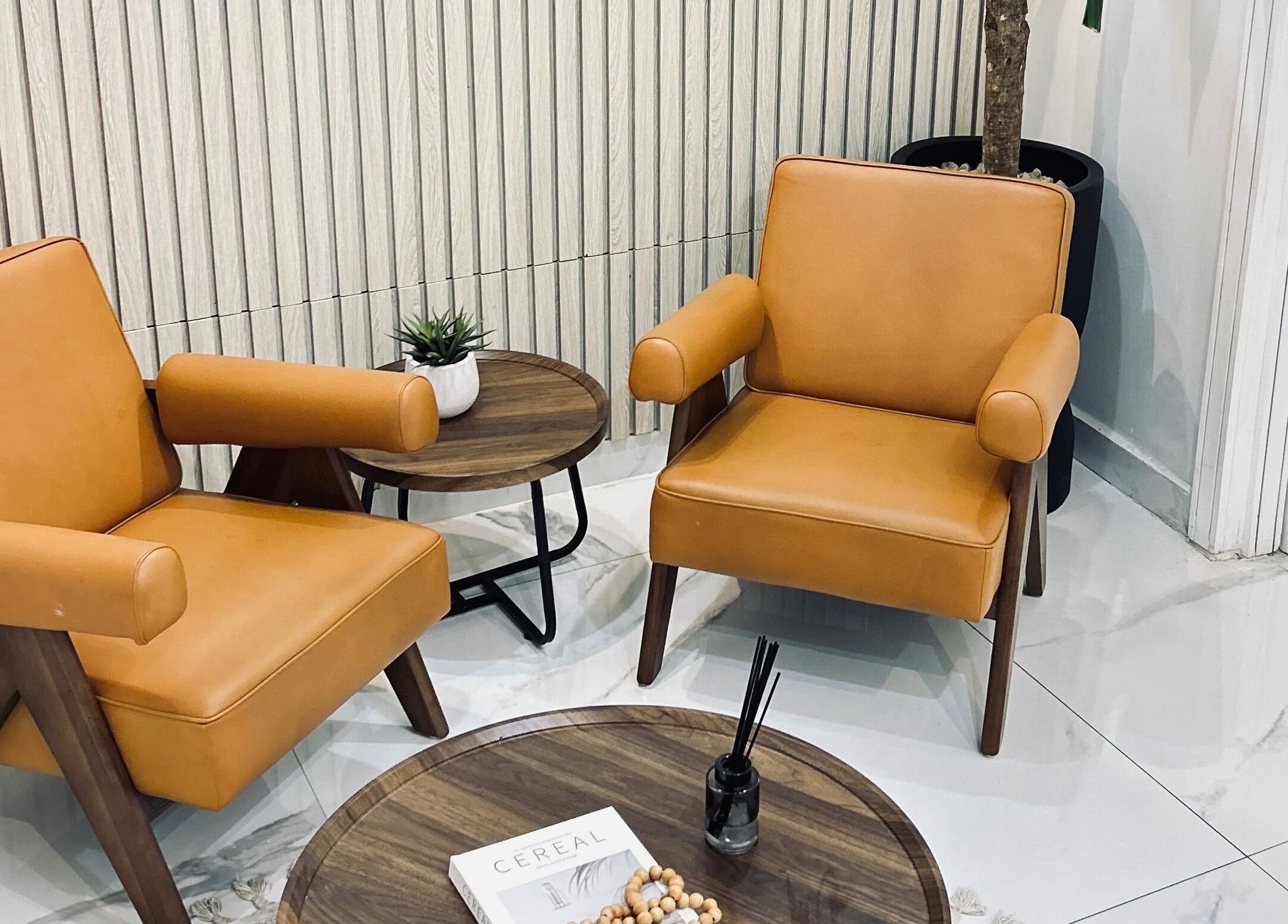 Stylish lounge area at VCP Laser and Aesthetics Clinic & Spa, Lagos, Lagos, NG, featuring leather chairs and chic decor.
