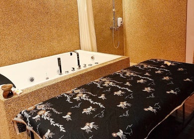 Luxurious spa room with massage table and bath at Yoyoy Kamphora Spa @ The Light Hotel Penang, Seberang Jaya, MY.