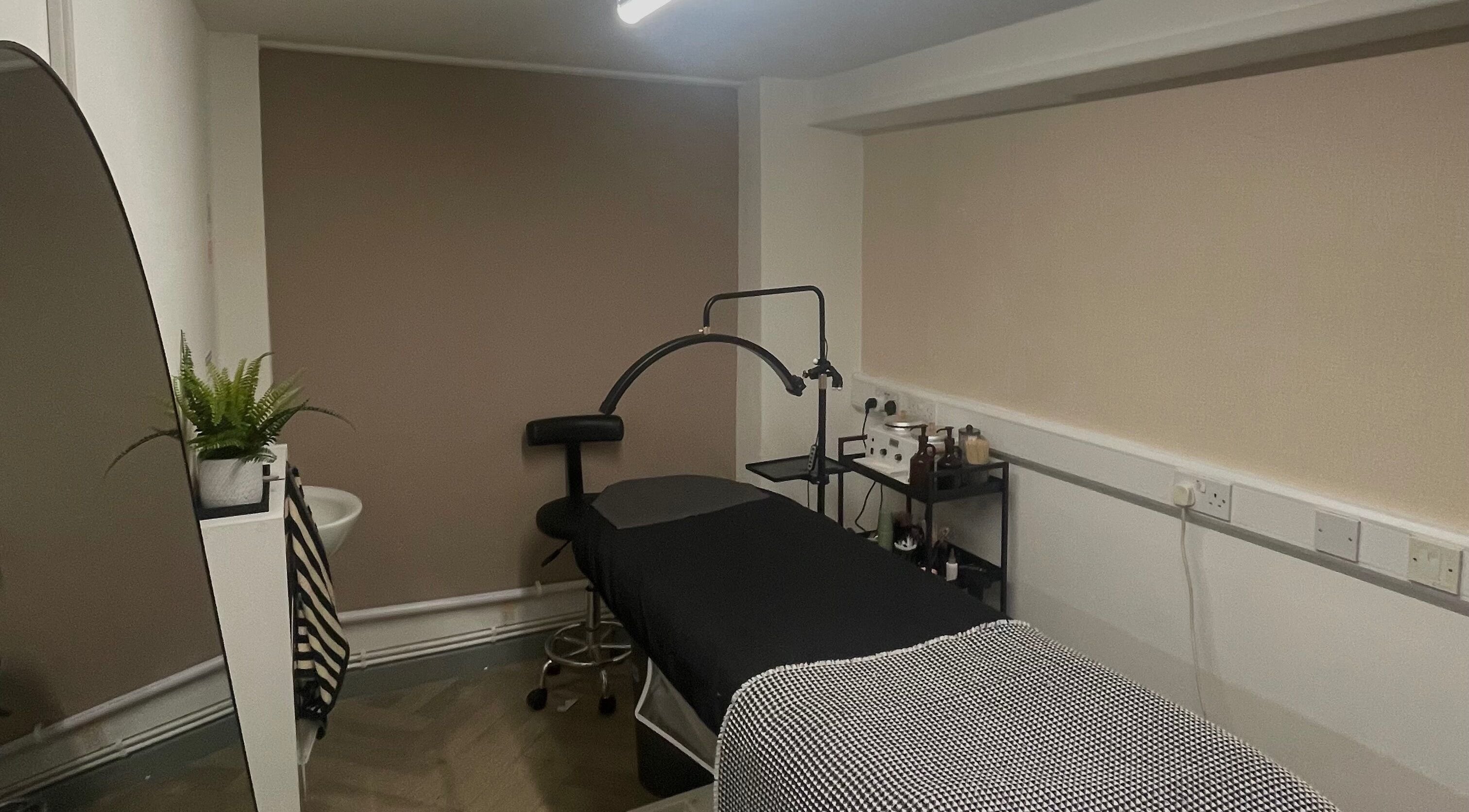 Relaxing treatment room at JL Beauty, Pontyclun, Wales, GB with a comfortable table and soothing decor.