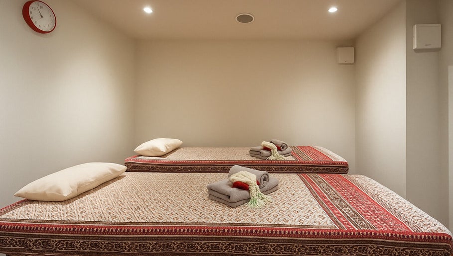 Twin massage beds at Even Thai Spa, London, England. Experience relaxation in a serene setting.