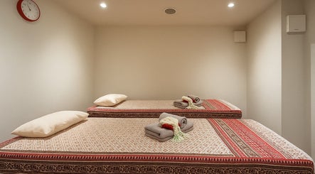 Twin massage beds at Even Thai Spa, London, England. Experience relaxation in a serene setting.