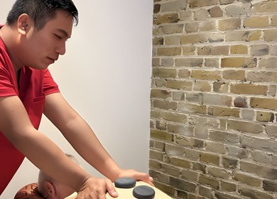 Therapist giving a massage at Even Thai Spa, London, England, GB.