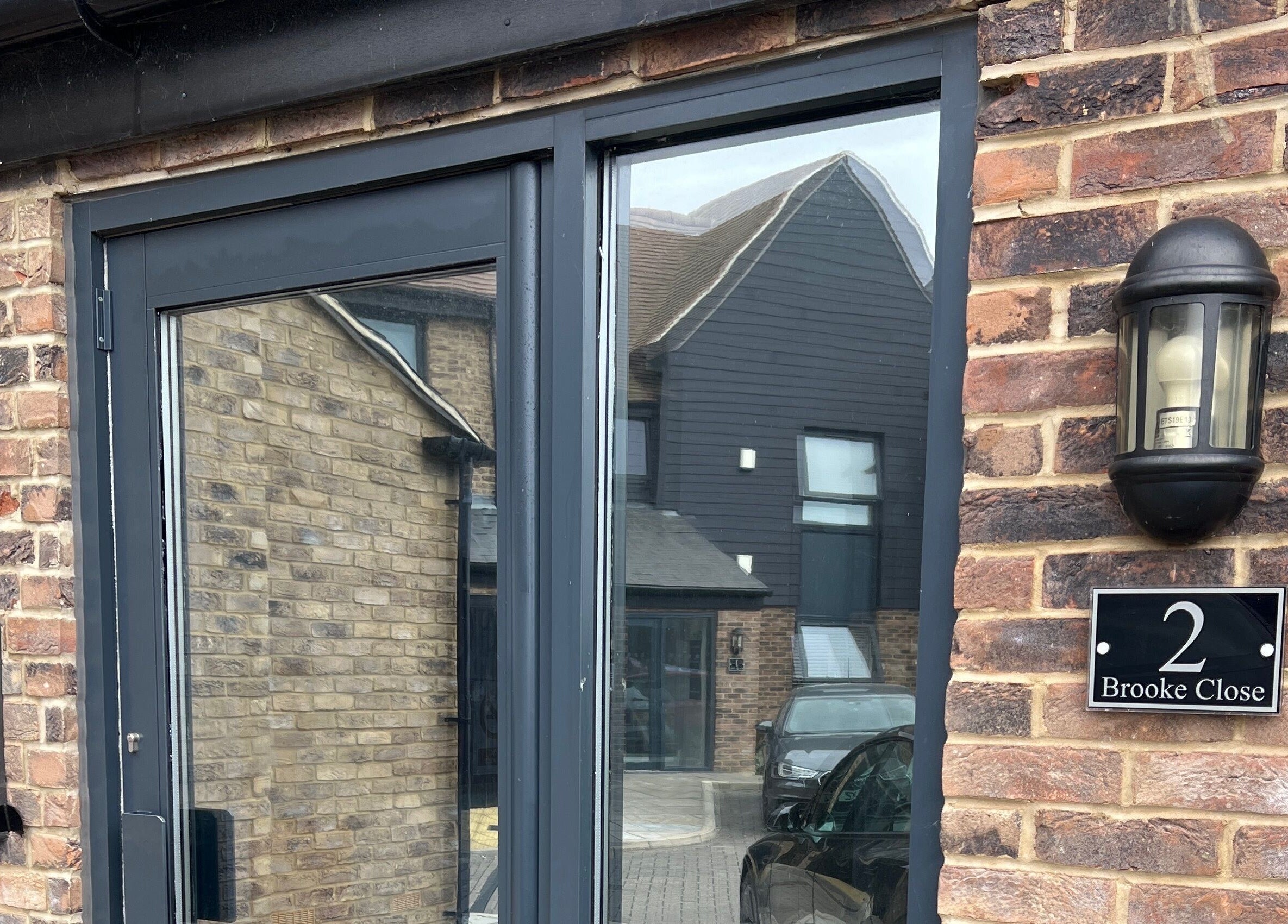 Entrance of Simply Nails by Jess in Margate, England, showcasing a modern brick facade and sleek design.