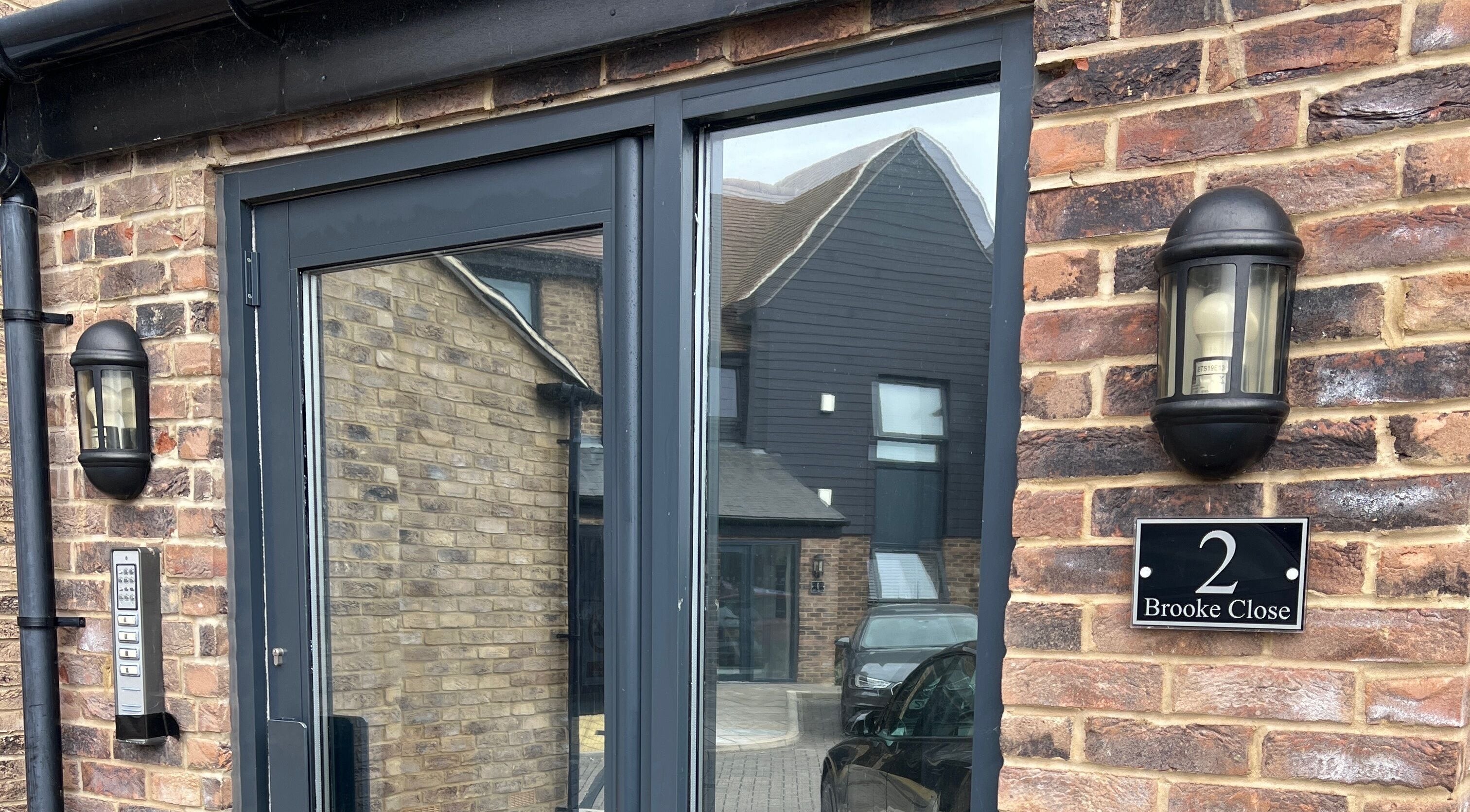 Entrance of Simply Nails by Jess in Margate, England, showcasing a modern brick facade and sleek design.