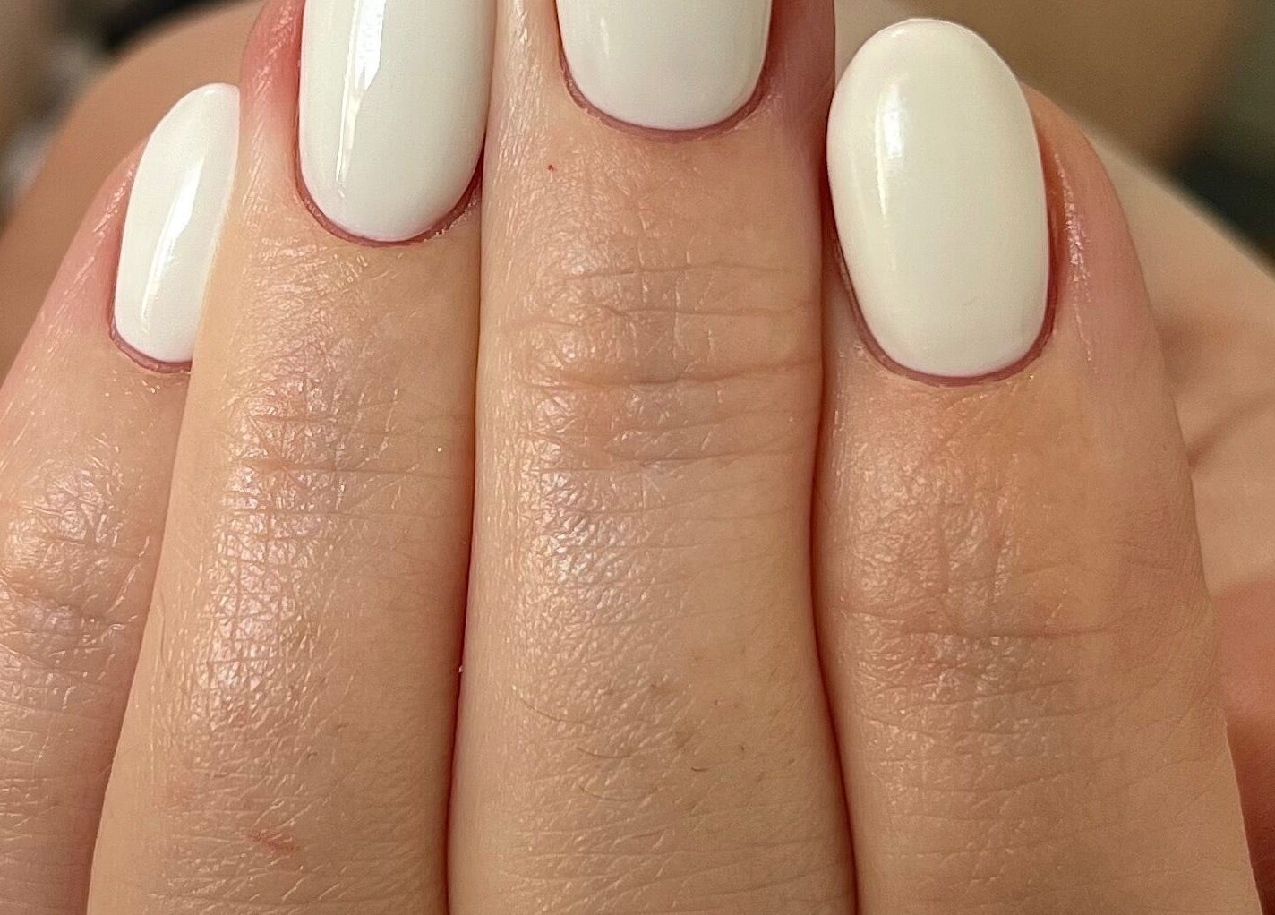 Close-up of elegant white manicure at Simply Nails by Jess in Margate, England, GB.
