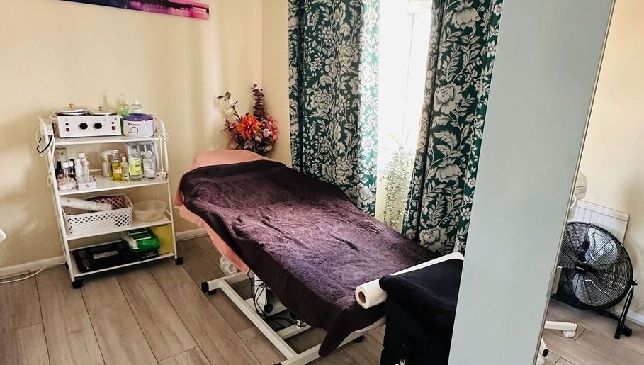 Relaxing treatment room at Nudeblush Studio, Stanwell, England, GB with massage table and soft lighting.
