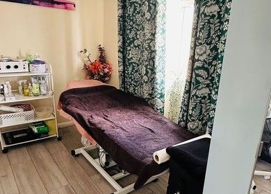Relaxing treatment room at Nudeblush Studio, Stanwell, England, GB with massage table and soft lighting.