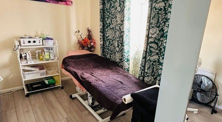 Relaxing treatment room at Nudeblush Studio, Stanwell, England, GB with massage table and soft lighting.