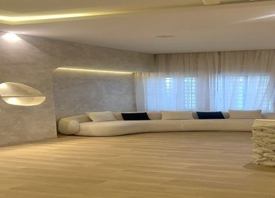 Elegant lounge at The Bougie & Co, Lagos, Lagos, NG featuring a curved sofa and modern decor.