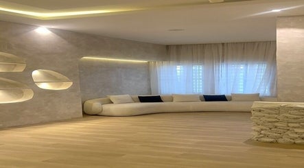 Elegant lounge at The Bougie & Co, Lagos, Lagos, NG featuring a curved sofa and modern decor.