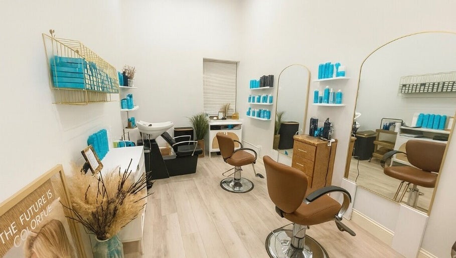 Chic interior of Deep Roots Hair Atelier, Riverhead, New York, US, featuring styling chairs and modern decor.