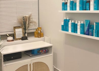 Product display at Deep Roots Hair Atelier in Riverhead, New York, US, featuring quality hair care products.