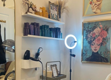 Interior of Deep Roots Hair Atelier in Riverhead, New York with hair products and artful decor.