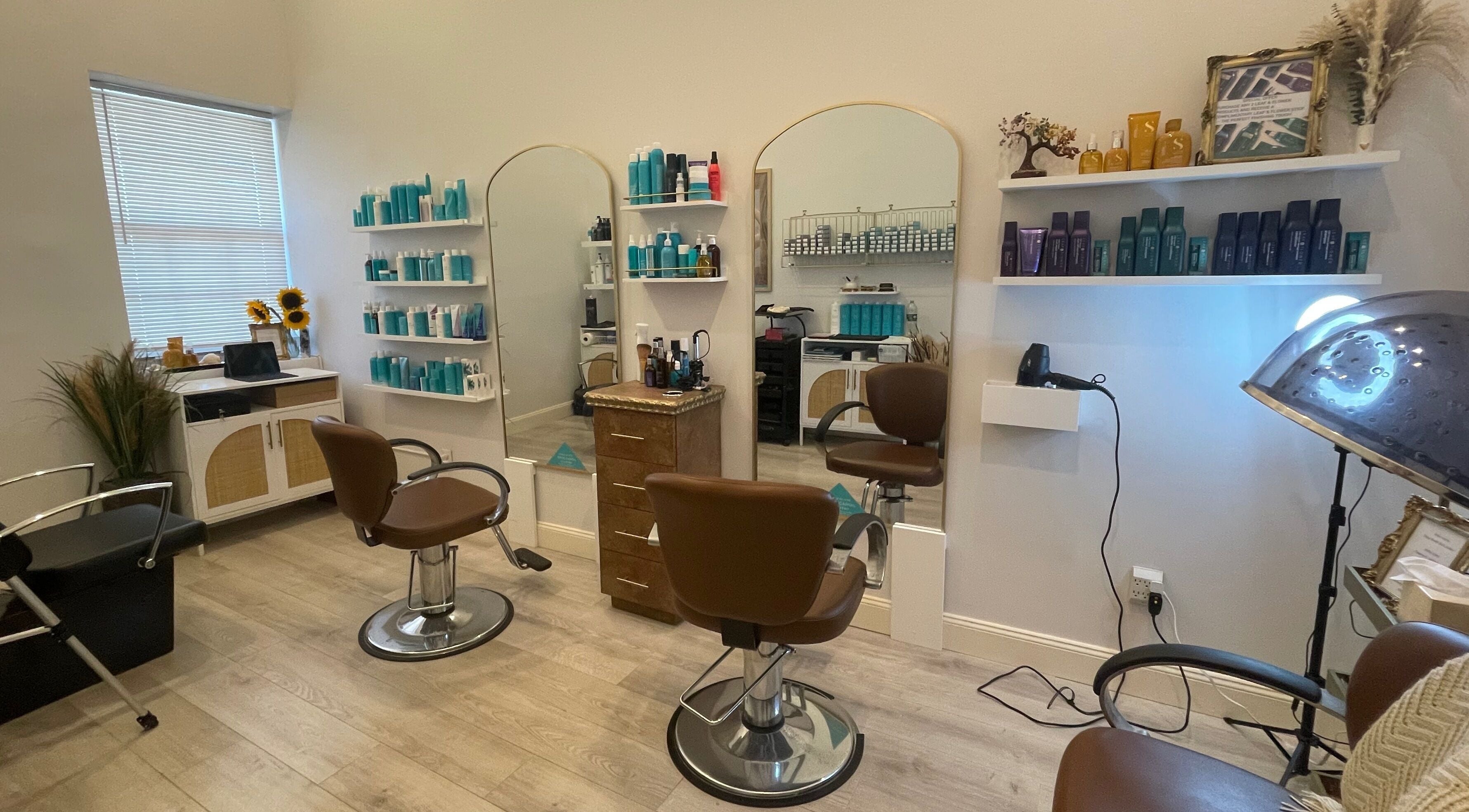 Modern salon interior at Deep Roots Hair Atelier, Riverhead, New York, US with chic chairs and mirrors.