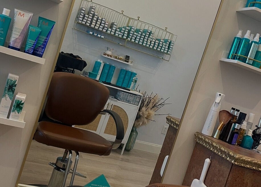 Interior view of Deep Roots Hair Atelier in Riverhead, New York featuring luxurious shelves with beauty products.