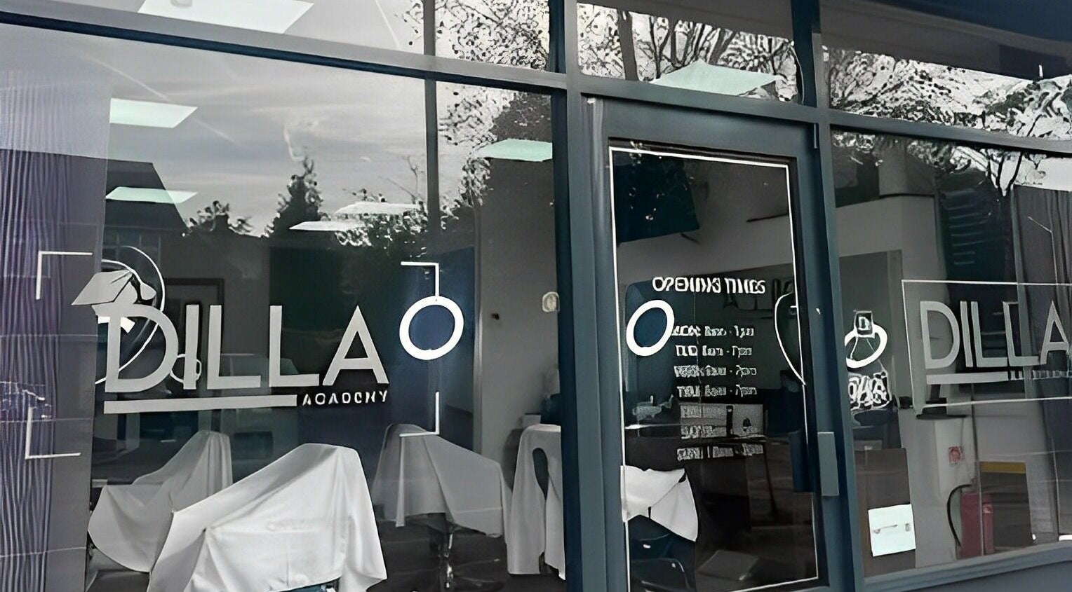 Chic exterior of Dilla Barbershop Urmston, located in Urmston, England, GB, showcasing its modern glass facade.