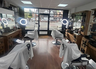 Interior of Dilla Barbershop Urmston, showcasing stylish barber chairs and mirrors in Urmston, England, GB.