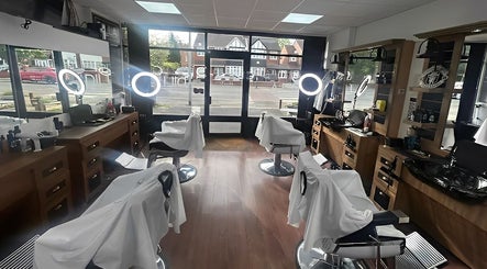 Interior of Dilla Barbershop Urmston, showcasing stylish barber chairs and mirrors in Urmston, England, GB.
