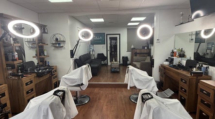Modern interior of Dilla Barbershop Urmston, England, GB featuring stylish chairs and ambient lighting.