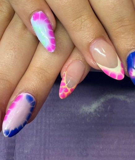 Vibrant nail designs at Nailsbykeaten, Ames, Illinois, US showcasing colorful butterfly patterns.