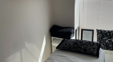 Tranquil massage room at Recover with Dora, Cambridge, England, GB, featuring black and white decor.