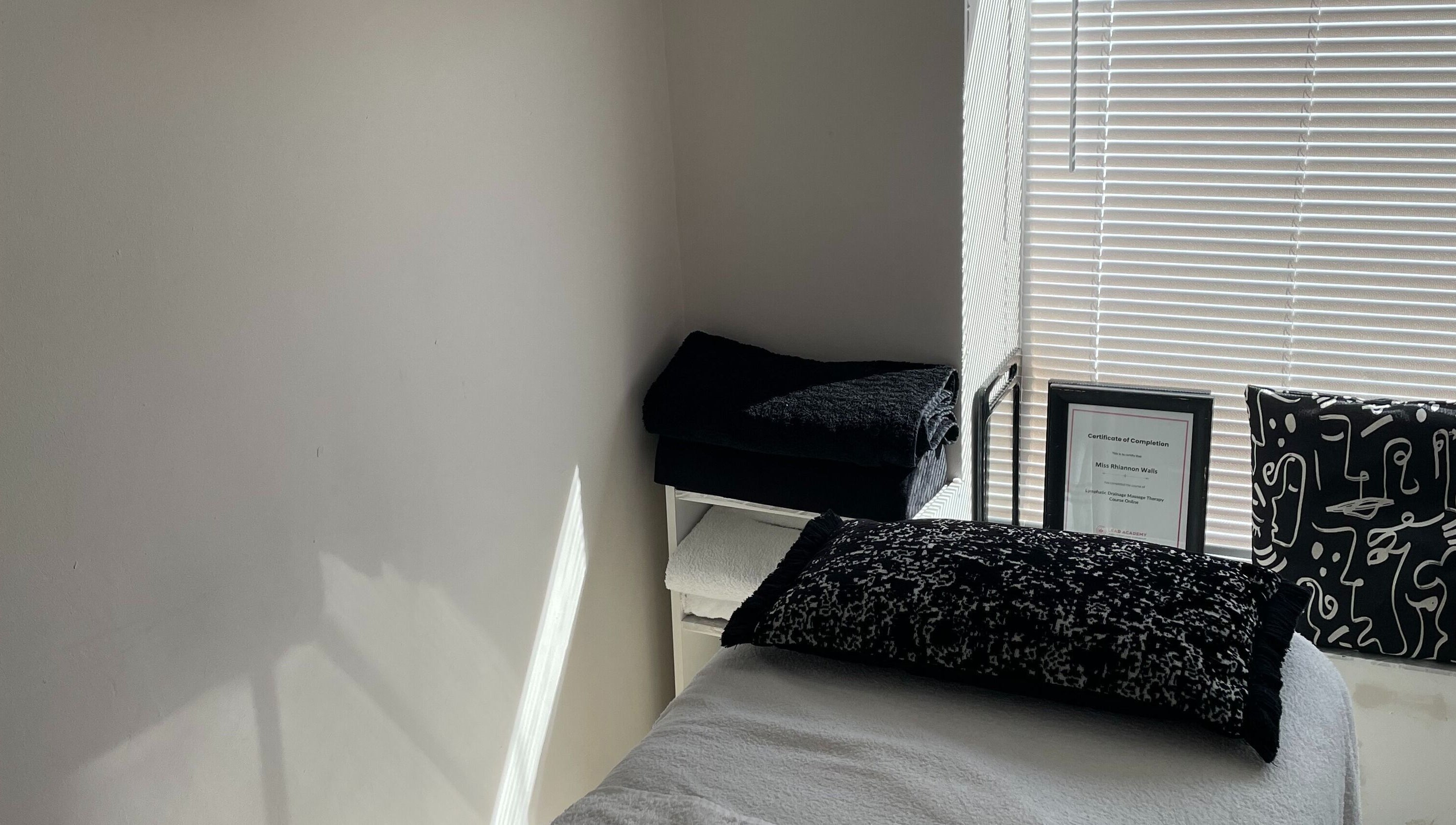 Tranquil therapy room at Recover with Dora, Cambridge, England, GB with a cozy bed and soothing decor.