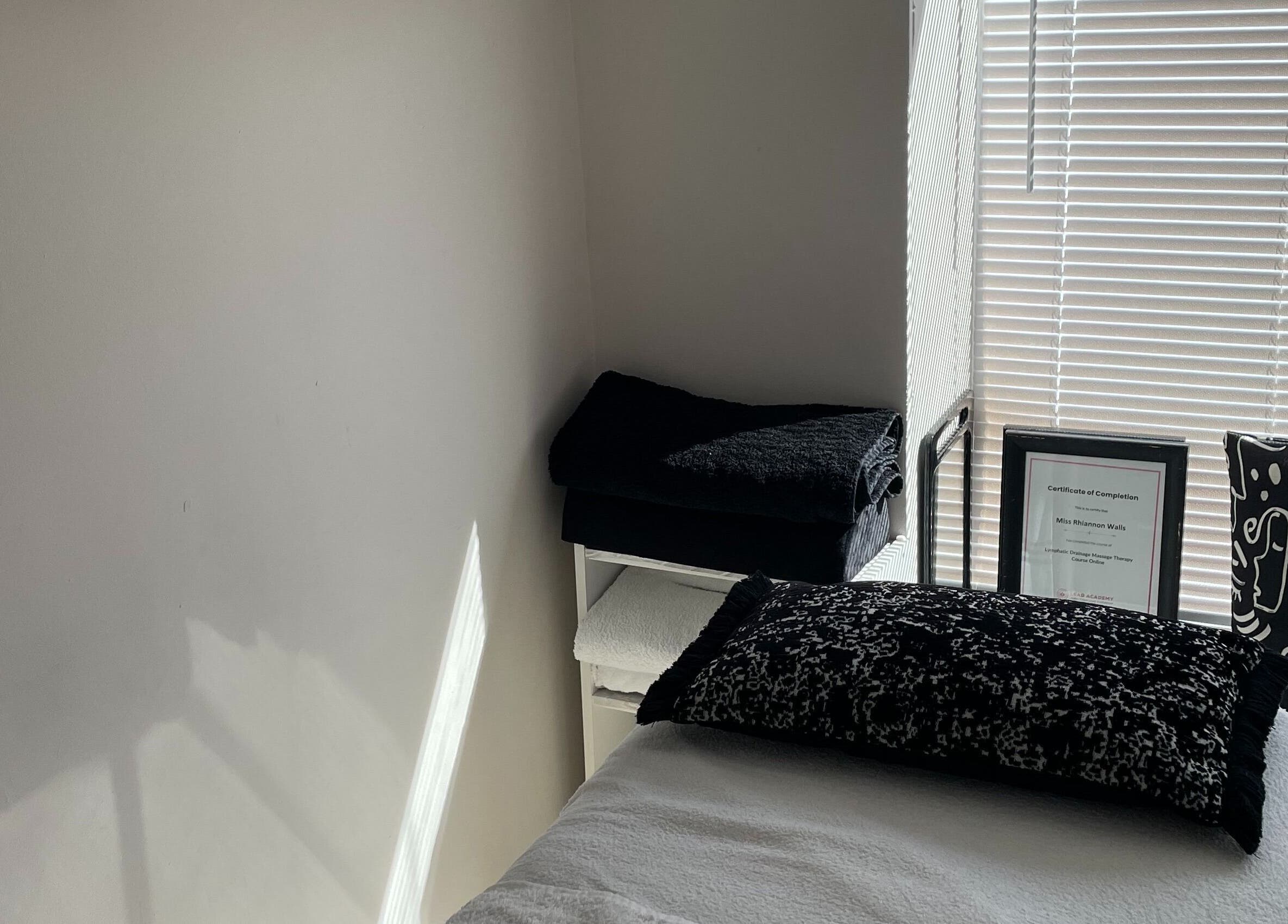 Tranquil therapy room at Recover with Dora, Cambridge, England, GB with a cozy bed and soothing decor.